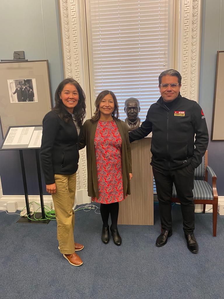 From left, Maria Barquin, communications fund program director, stands with Julie Rodriguez, senior advisor to President Biden at the White House and Cesar’s granddaughter, and La Campesina radio personality Tony “El Tigre” near a bust of Martin Luther King Jr. 